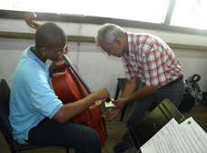 Heemath Jahoor helps tune the cello